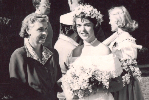 black and white photo of two women, one with flowers